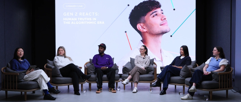 Image of a Group of Men and Women Sitting in Individual Comfy Chairs Having a Panel Discussion
